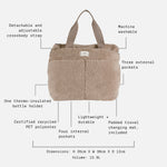 Sigrid beige shown on a light gray background with callout lines and text listing features such as detachable adjustable crossbody strap, three external pockets, machine washable, bottle holder, recycled polyester, and dimensions and volume.