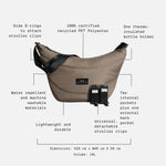 Osma mocha bag with black straps and black stroller clips, shown with callout text and dotted lines explaining features and dimensions on a light gray background.
