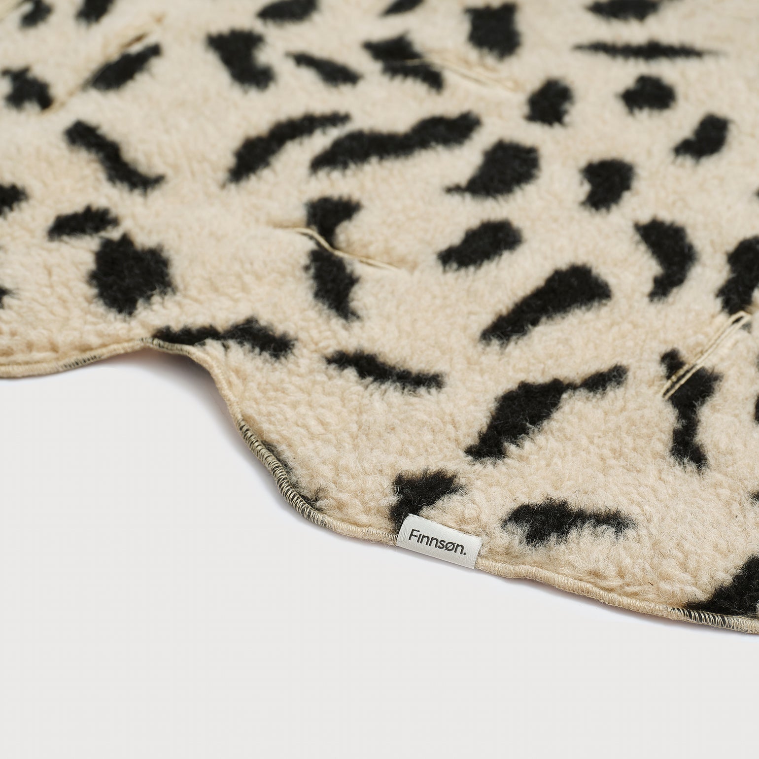 Close-up of astor merino wool lining and 'Finnson' branding.