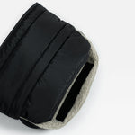 A close-up of the finnson black quilted puffer stroller mitten with a light gray sherpa lining, shown on a clean white background.