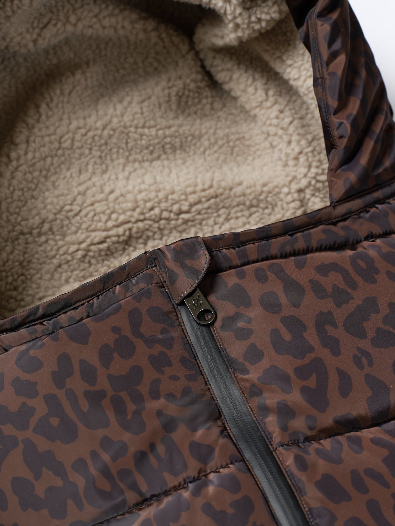 Close-up detail shot of the zip on the alma universal footmuff in chocolate leopard