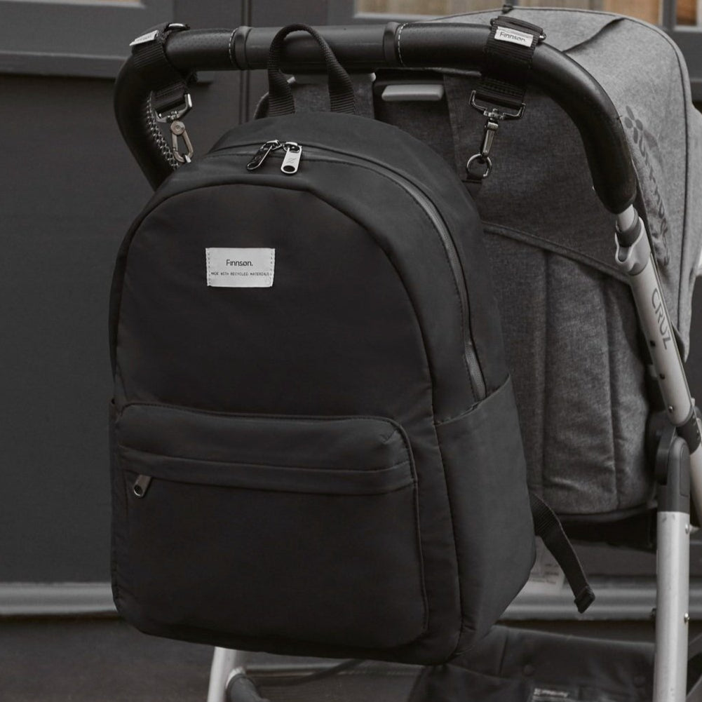 FINNSON ANA BLACK BACKPACK ON BACK OF PRAM