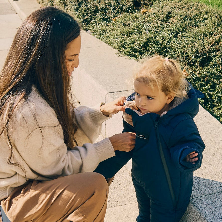 Woman and child outdoors, with child wearing Anders navy snowsuit 