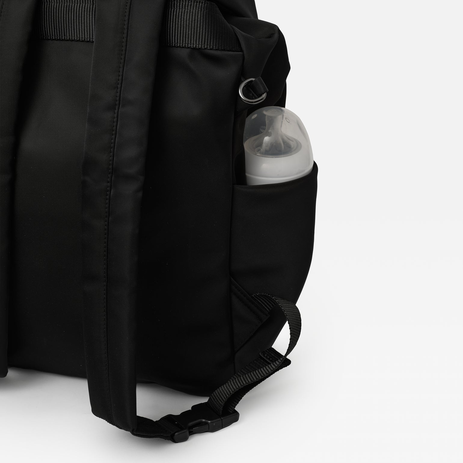 Elise Black changing backpack with a pocket containing a baby bottle on a white background