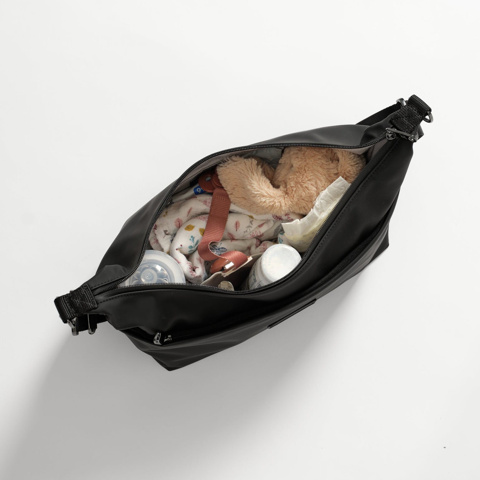Fia Black changing bag filled with various items on a white background