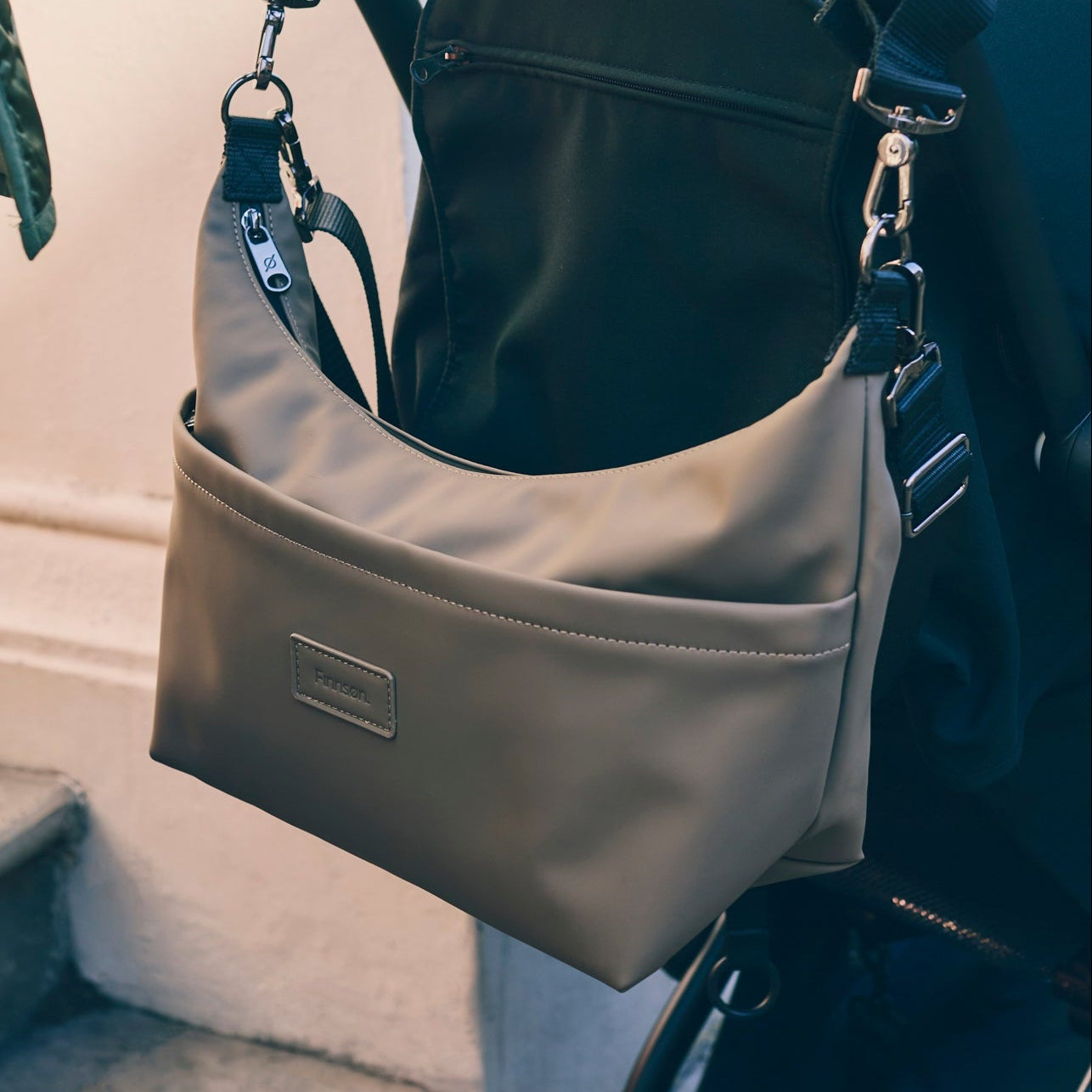 Fia mocha stroller organiser with a visible brand logo attached to a stroller.