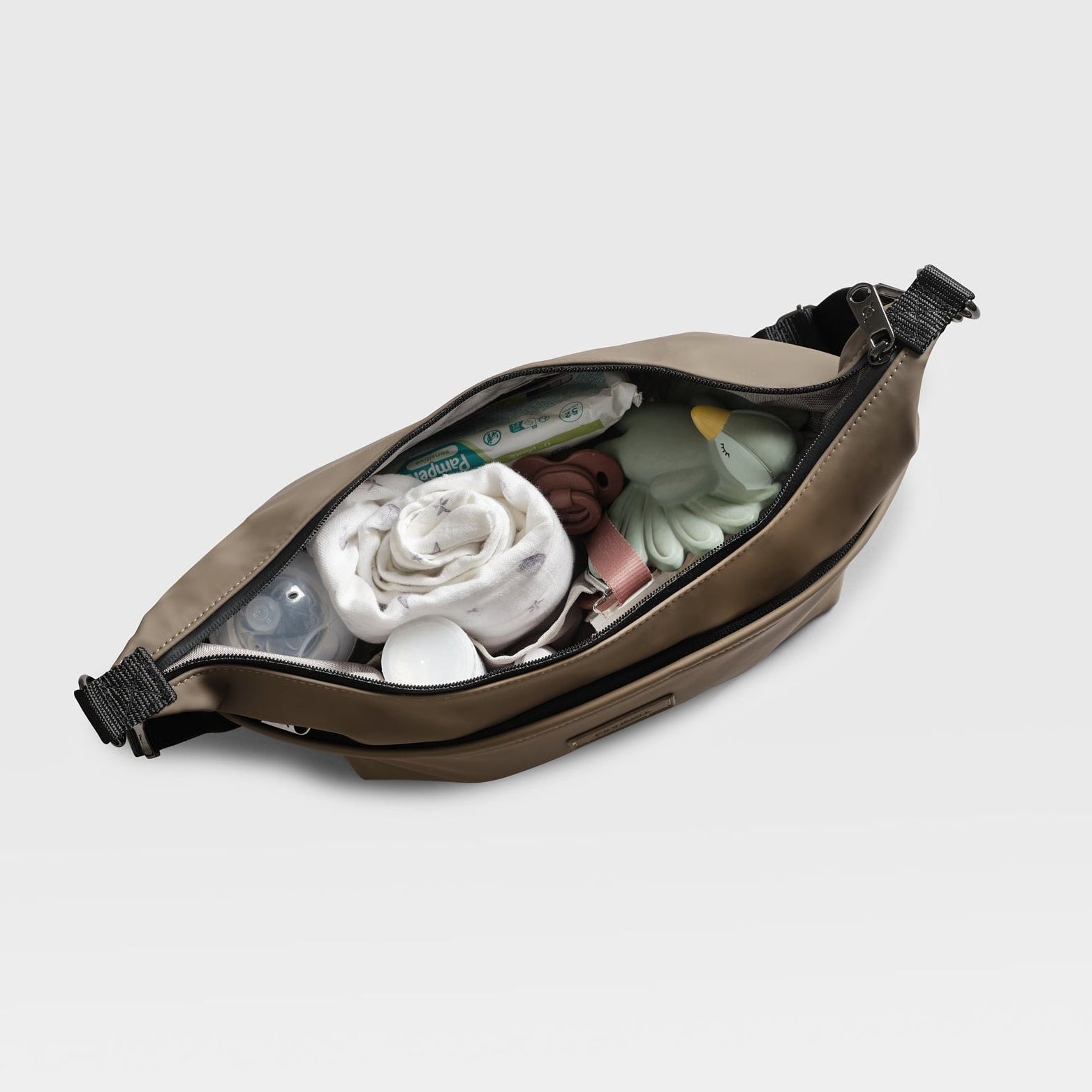 Fia mocha stroller organiser birds eye view of open bag with various items on a light gray background