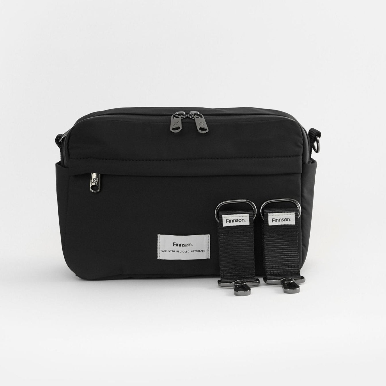 Black Frida eco stroller organiser with stroller clips, featuring multiple pockets and a shoulder strap, displayed against a white background.