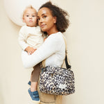 FINNSON FRIDA STROLLER ORGANISER LEOPARD MODEL WEARING ON SHOULDER HOLDING BABY 