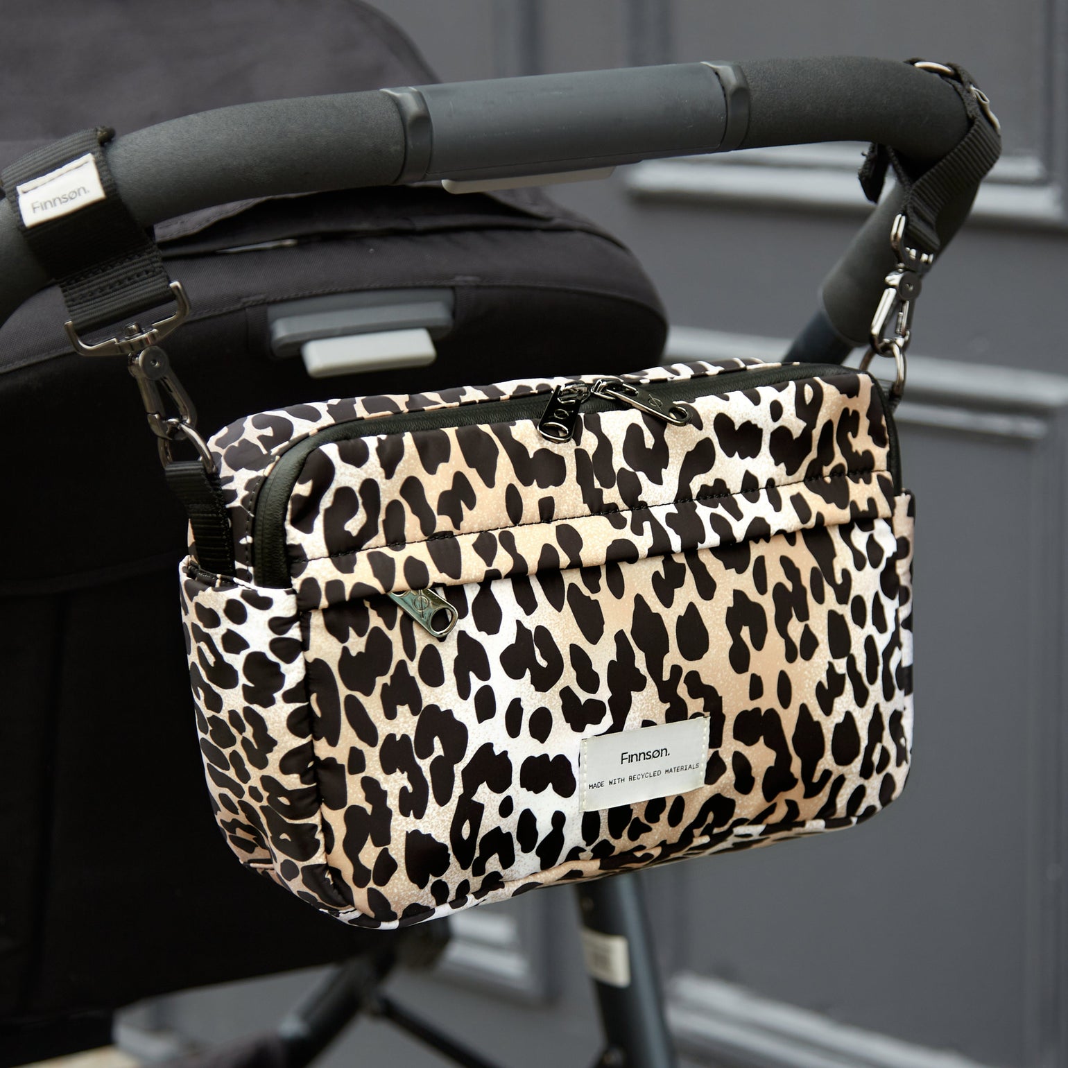 Frida eco stroller organiser leopard attached to back of black pram