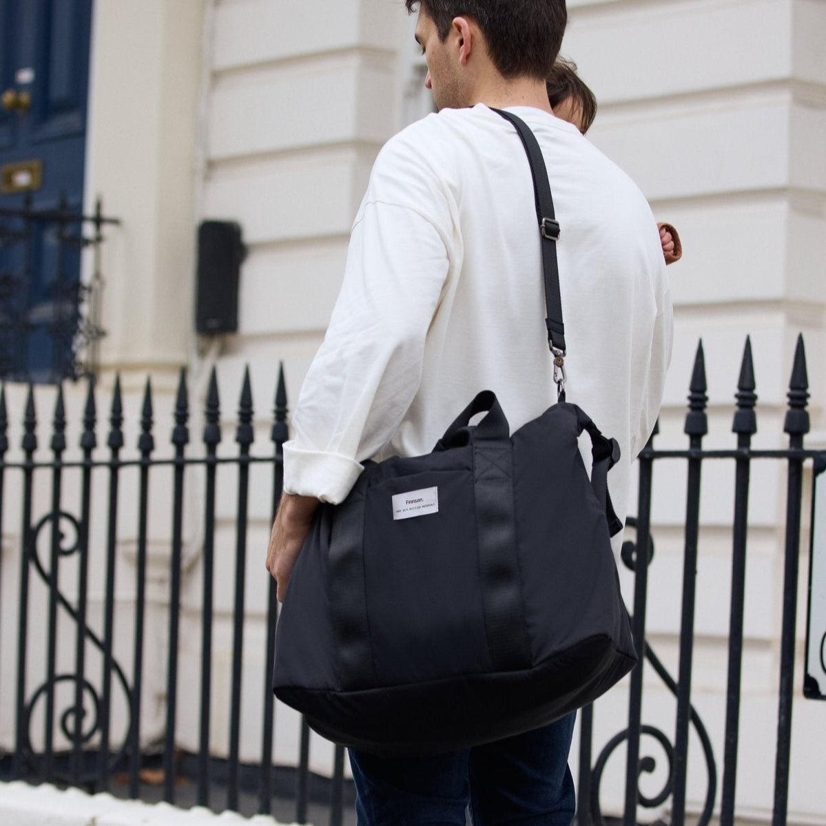 FINNSON IDA HOLDALL BLACK FATHER CARRYING BABY AND BAG