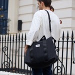 FINNSON IDA HOLDALL BLACK FATHER CARRYING BABY AND BAG