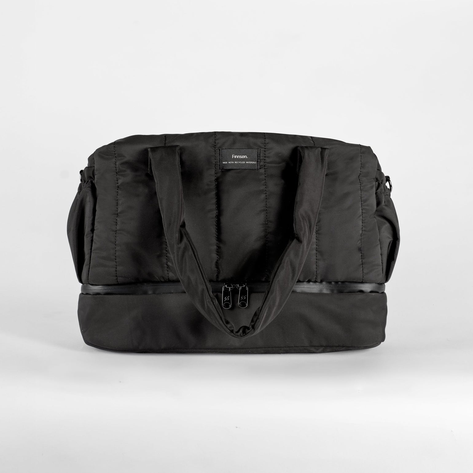 Innes quilted black changing bag in white background