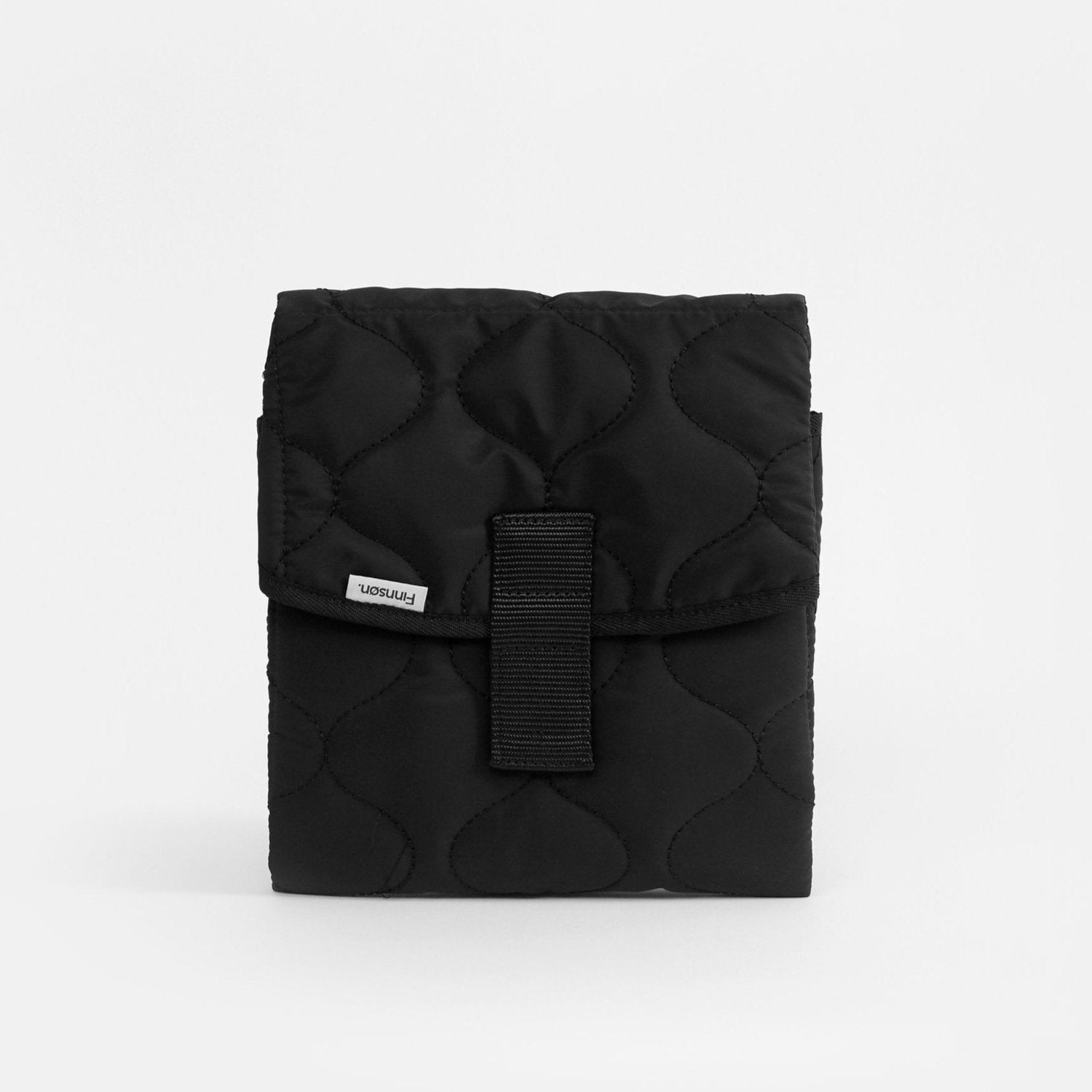Kari black changing mat with a strap and a label visible on the front.