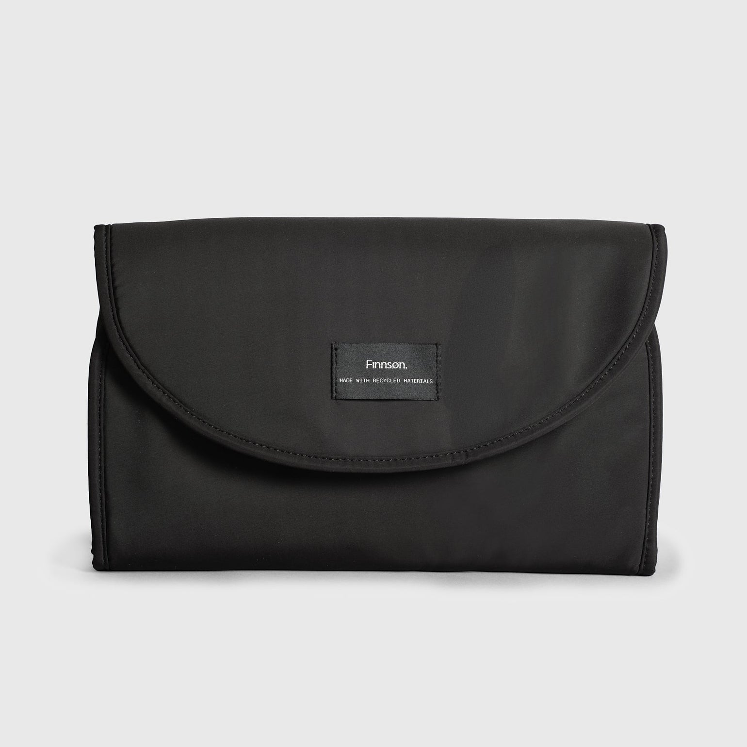 Oslo black changing mat with a brand label on a light gray background
