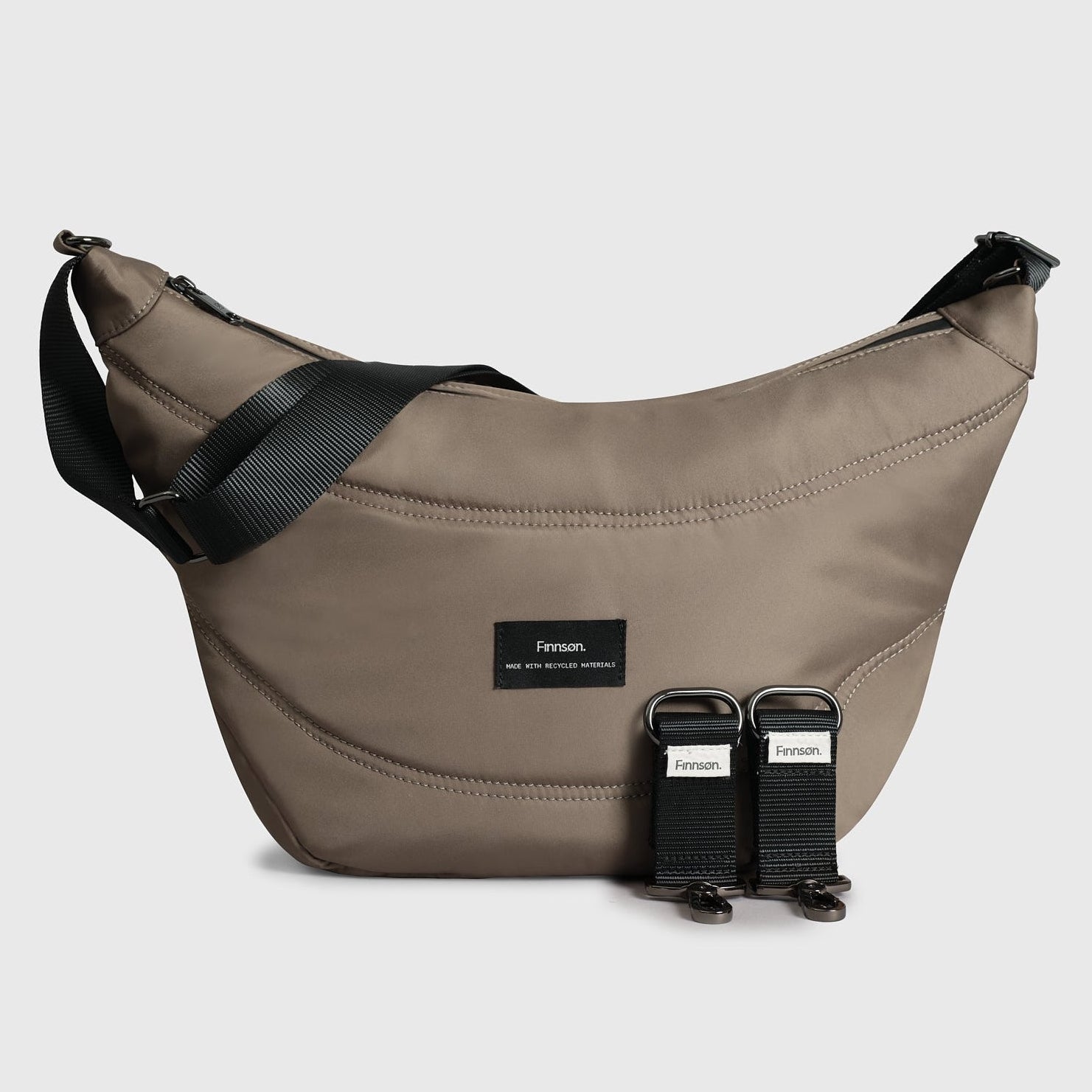Osma mocha sling stroller organiser with black straps on a light gray background