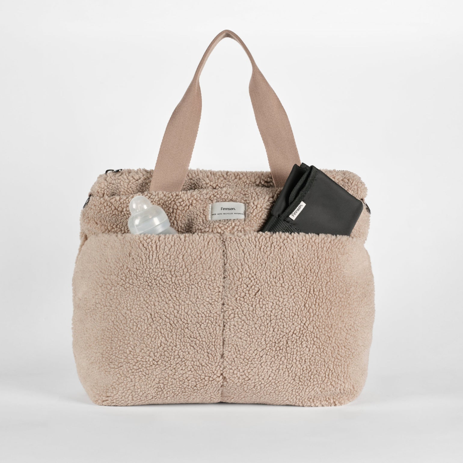 Sigrid mocha borg changing bag with black padded changing mat and white bottle on a white background