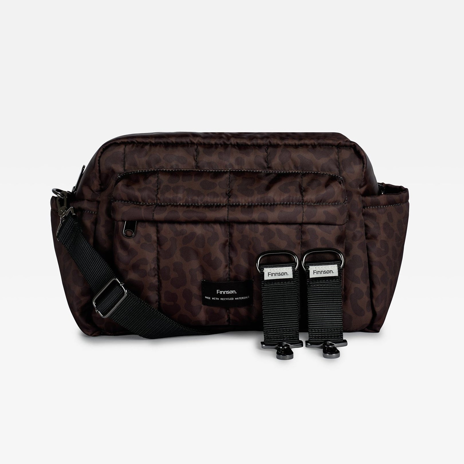 A dark brown and black leopard print crossbody bag with a black adjustable strap and two black buckle attachments, displayed against a clean white background.