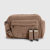 Freya mocha borg bag with an adjustable shoulder strap and two front buckle straps, shown on a light gray background.