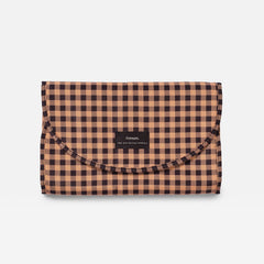 Oslo gingham check patterned travel changing mat, featuring a flap closure and a small black brand label that reads Finnson
