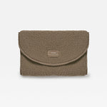 A mocha teddy changing mat with a small rectangular woven label on the front flap, set against a plain white background.