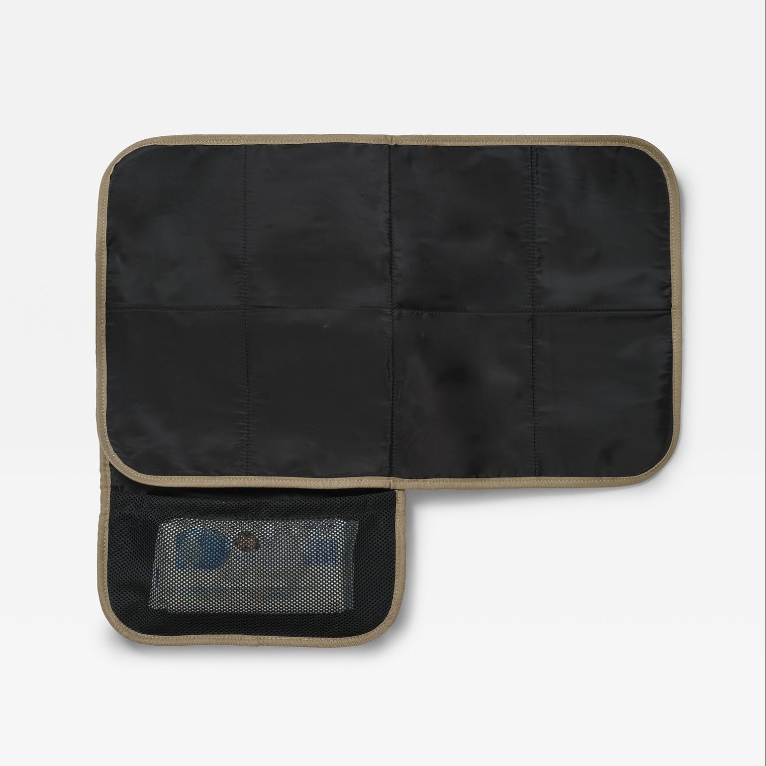 A padded travel changing mat with mocha trim, shown open to reveal multiple interior compartments and a mesh pocket containing toiletry items, on a light gray background.