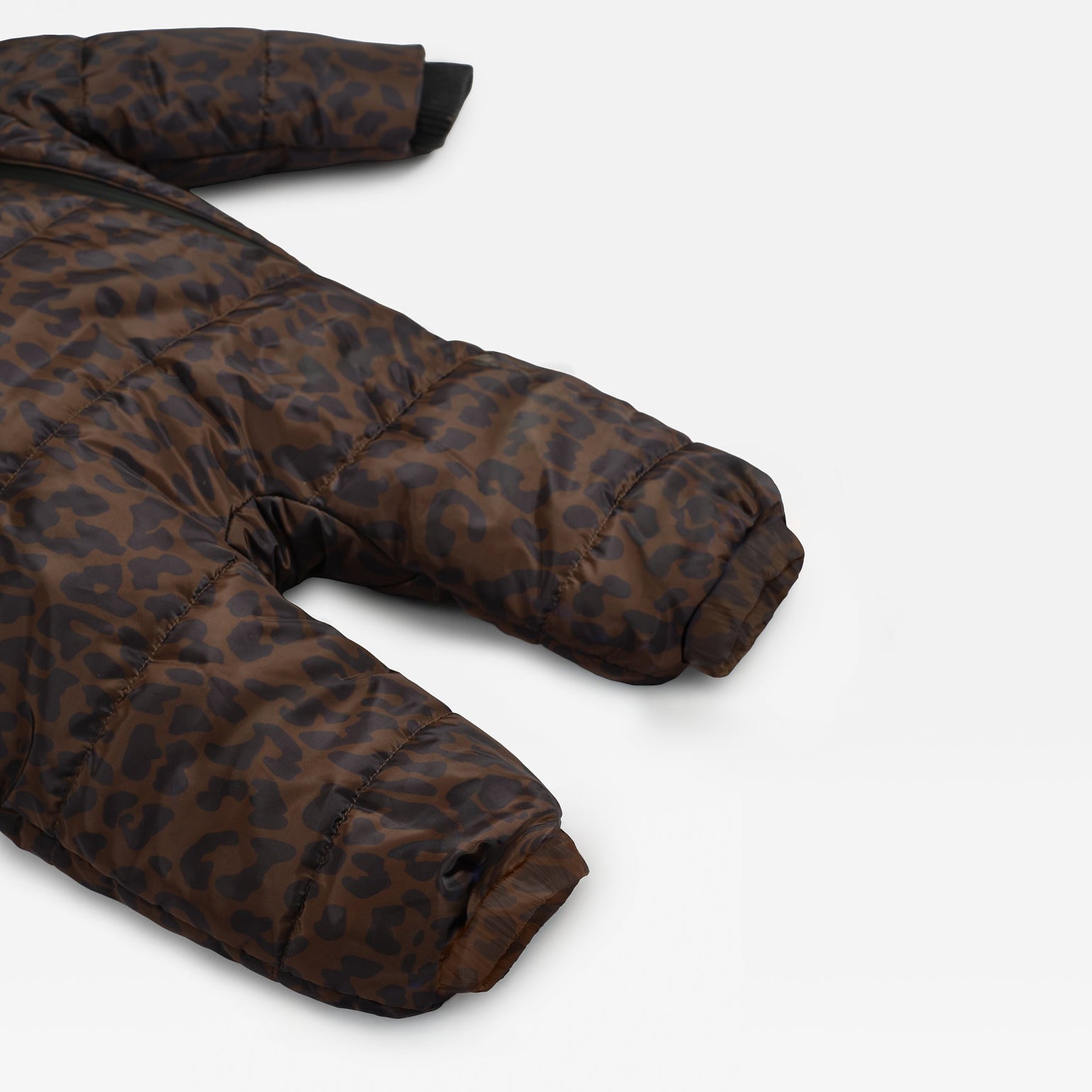 A close-up of the Anders brown and black leopard-print puffer snowsuit laid flat on a light gray background.