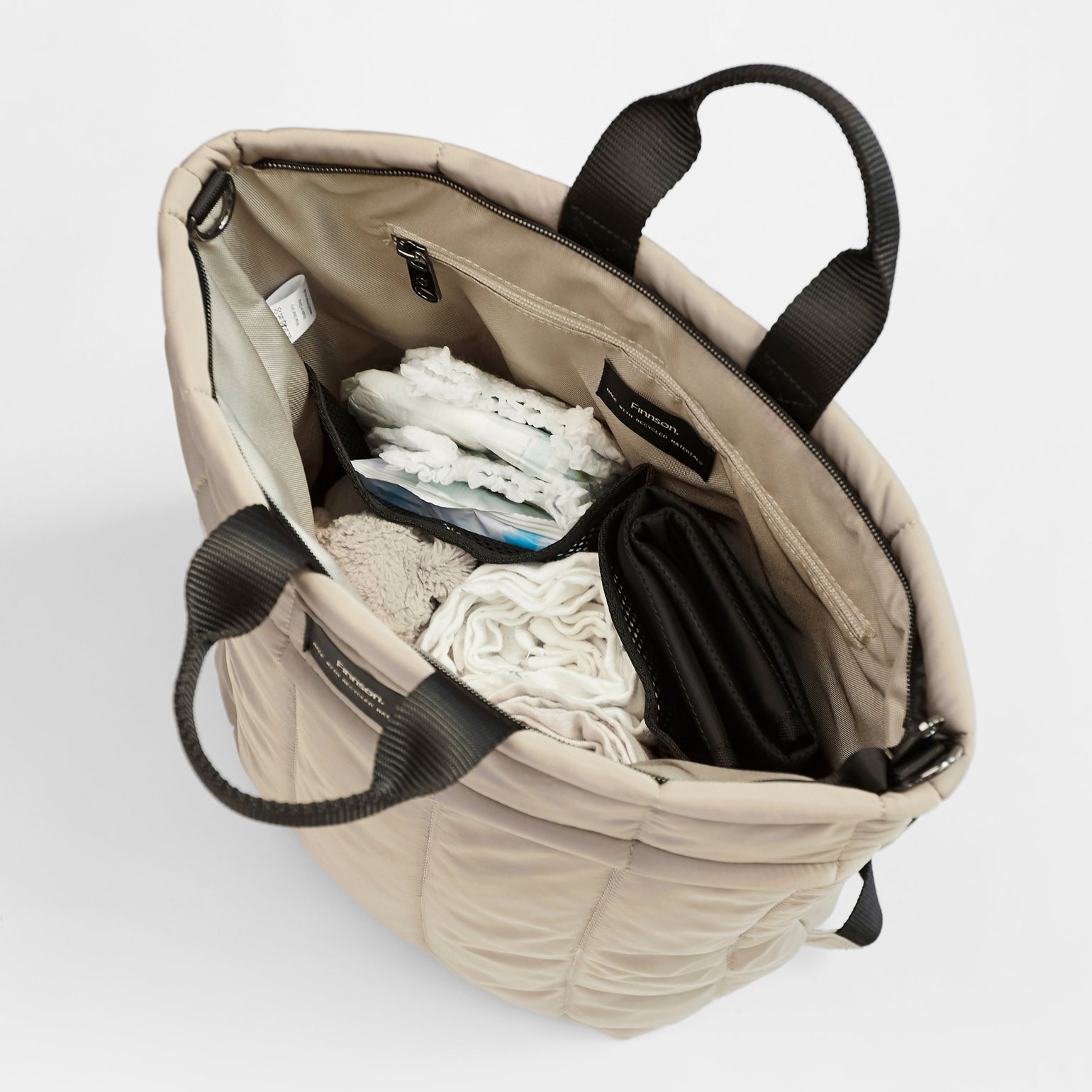 Rae Taupe Eco Changing Backpack with baby essentials neatly organised inside, showcasing its spacious and practical design.